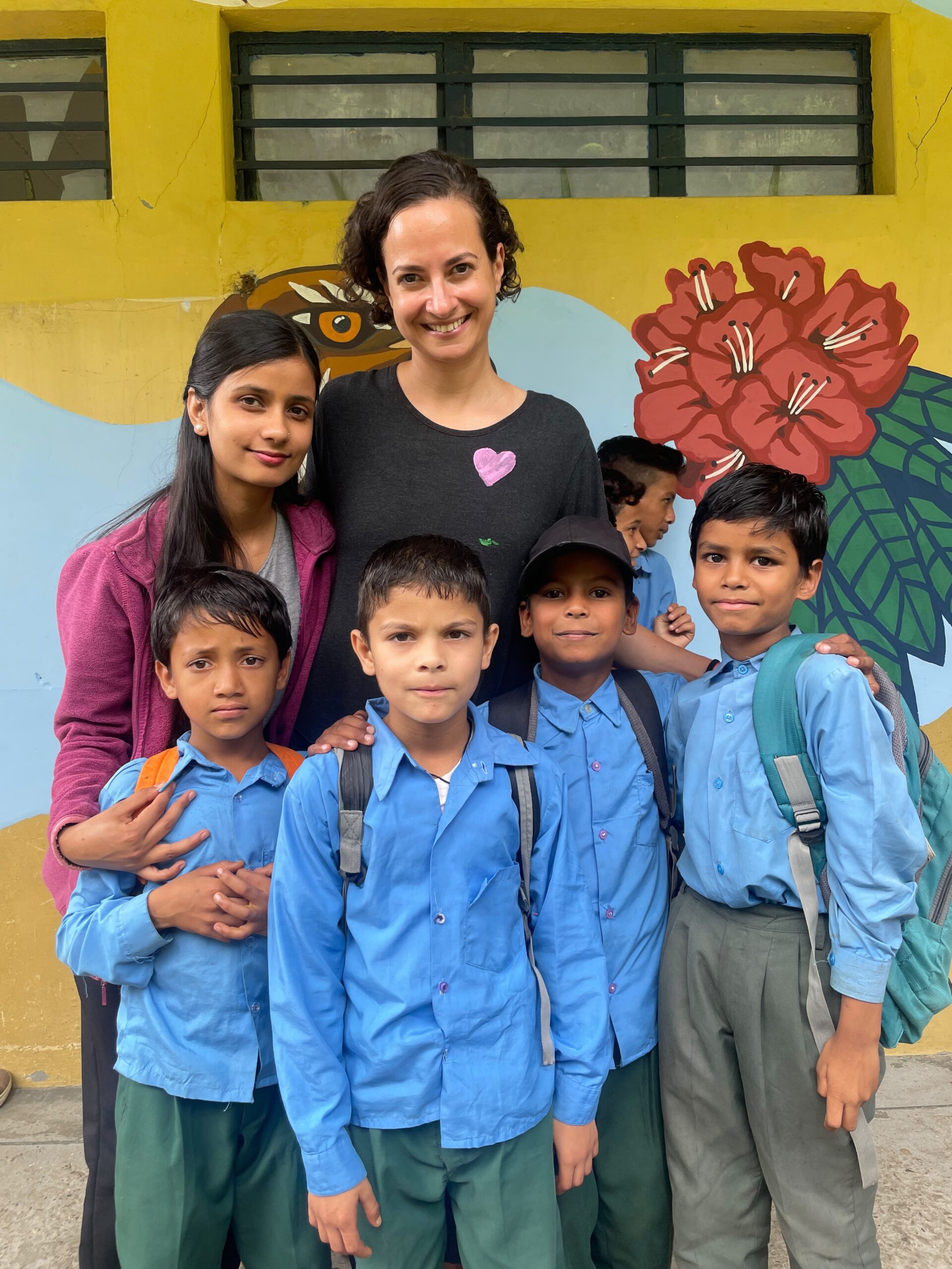 A teacher with a group of the younger children