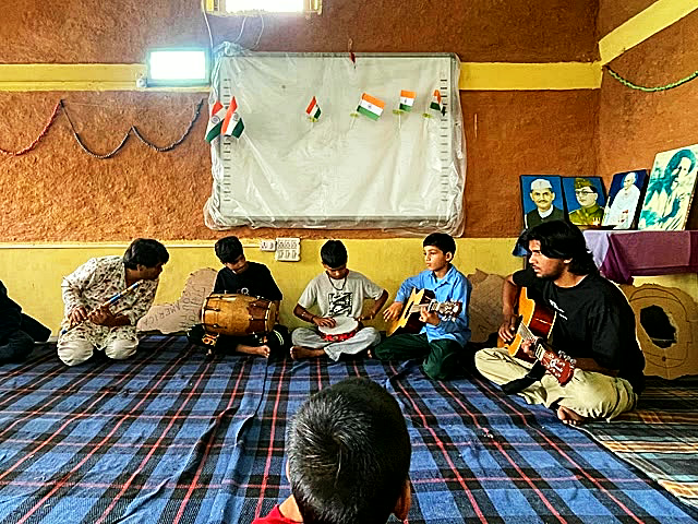 The student band playing guitar and drums
