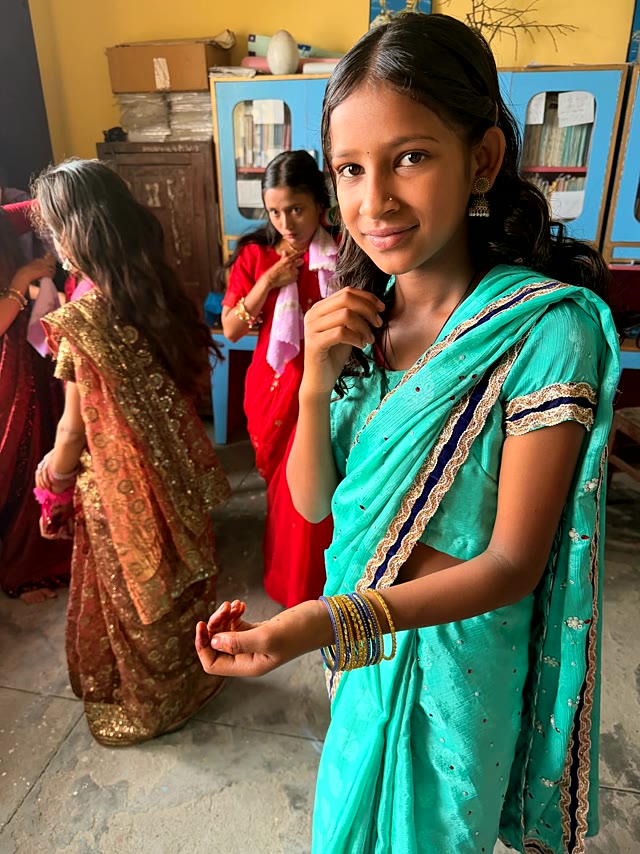 A student in a teal sari