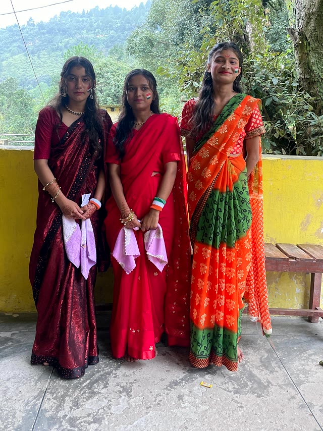 Three students in saris outside