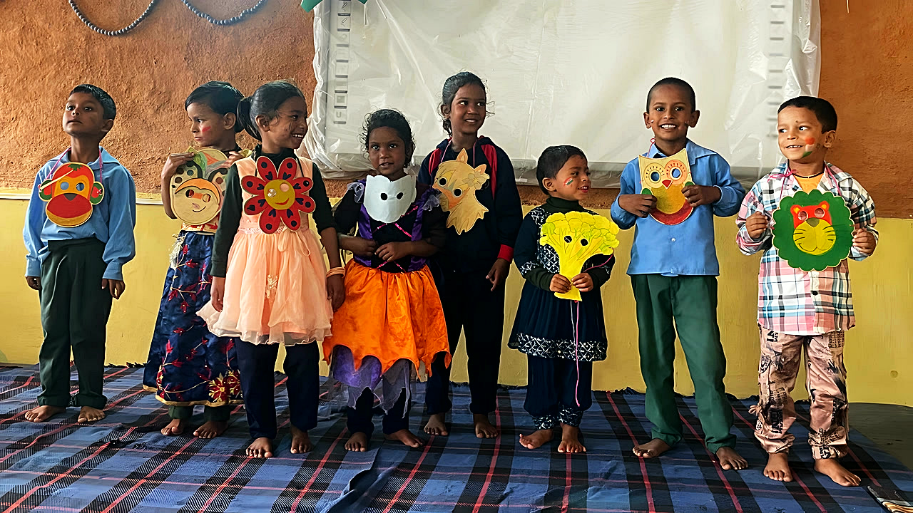 The youngest students in a line holding their animal masks